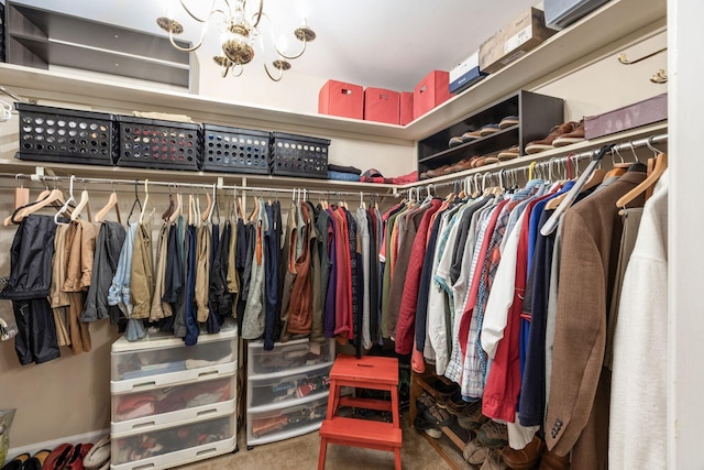 spacious closet featuring a chandelier