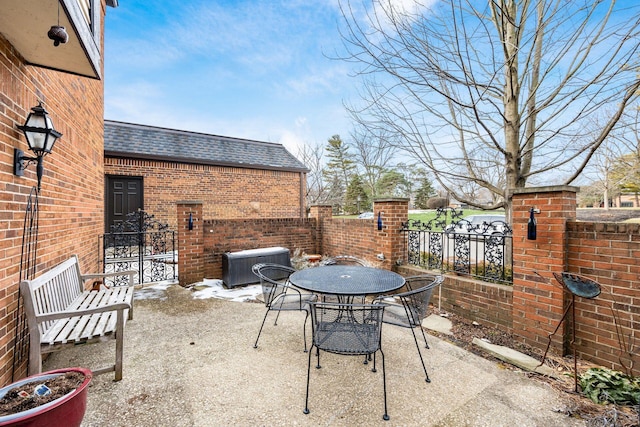 view of patio featuring outdoor dining space, central AC, and fence