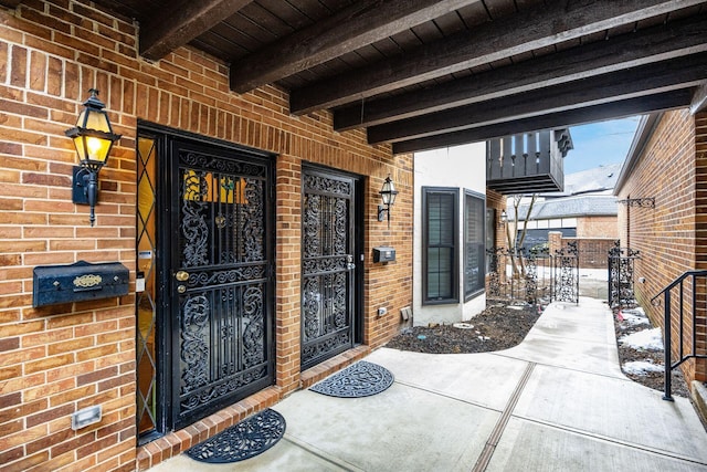 view of exterior entry with brick siding