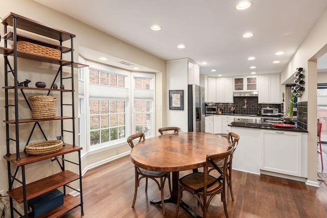 dining space with dark wood-style floors, a toaster, baseboards, and recessed lighting