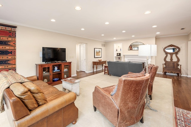 living area featuring a fireplace, crown molding, recessed lighting, light wood-style flooring, and baseboards