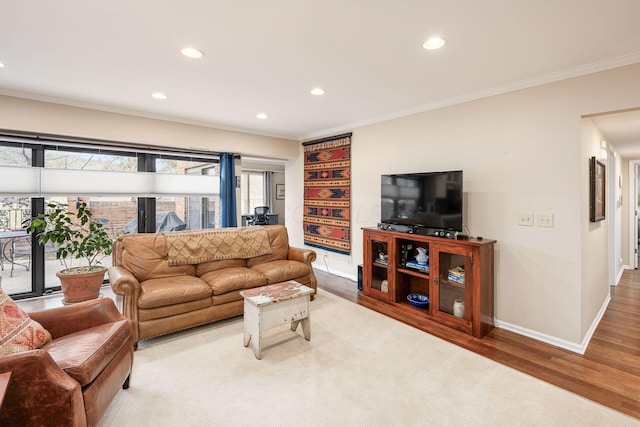 living room featuring baseboards, ornamental molding, wood finished floors, and recessed lighting