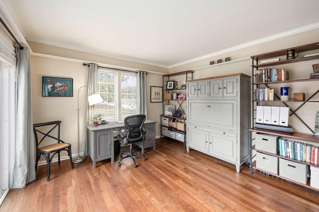 office space featuring crown molding, light wood-style flooring, and baseboards