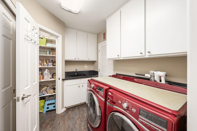 laundry area with dark wood-style flooring, a sink, cabinet space, and washer and dryer