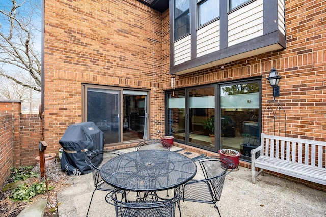 view of patio / terrace featuring outdoor dining space, a grill, and fence