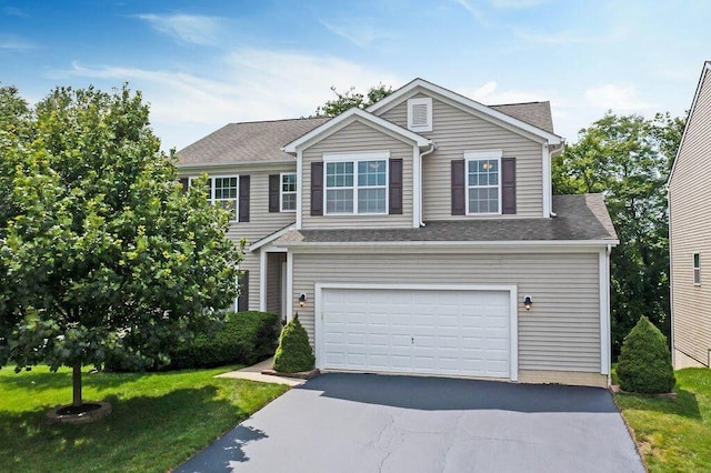 view of front facade with aphalt driveway, a front lawn, and an attached garage