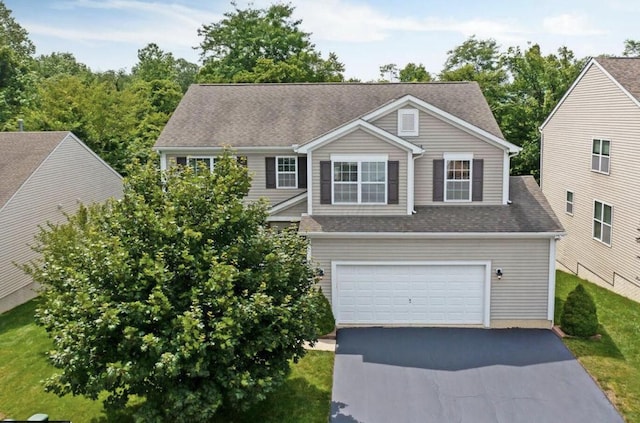 view of front facade featuring aphalt driveway, a shingled roof, and a garage