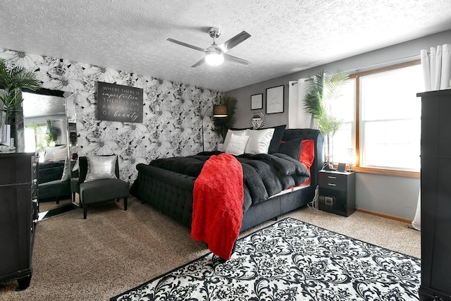 bedroom with light carpet, wallpapered walls, baseboards, ceiling fan, and a textured ceiling