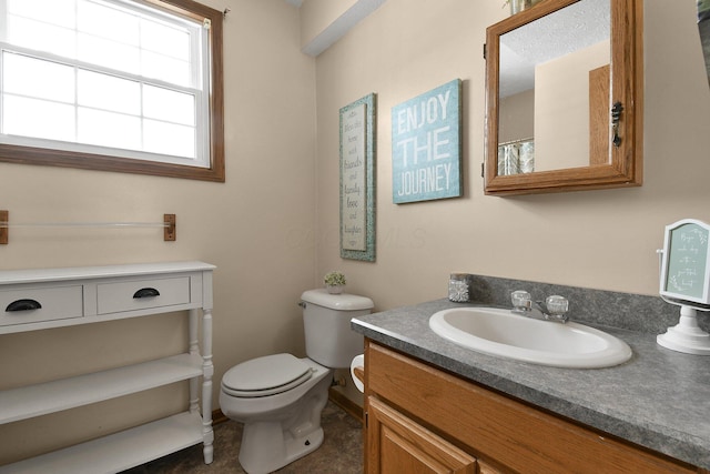 bathroom with toilet and vanity