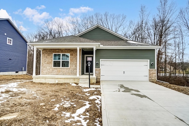 view of front of house with roof with shingles, covered porch, an attached garage, stone siding, and driveway