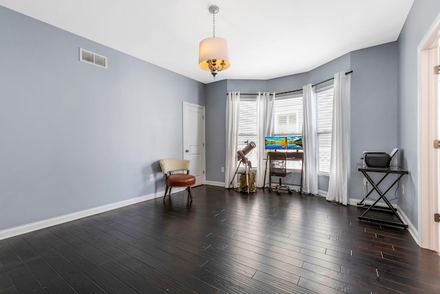 miscellaneous room featuring baseboards, visible vents, and dark wood-type flooring