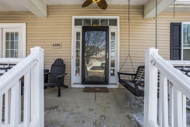 property entrance with ceiling fan