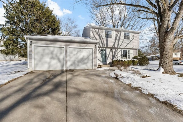 colonial inspired home with a garage and driveway