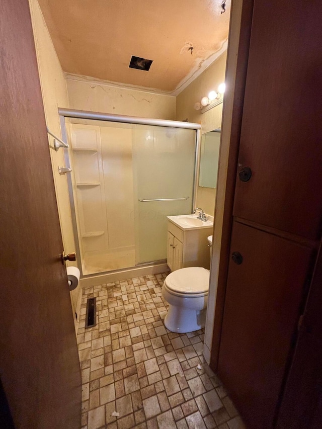 bathroom with toilet, a stall shower, ornamental molding, and vanity