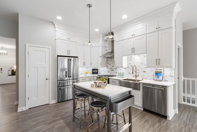 kitchen with stainless steel appliances, white cabinetry, and decorative light fixtures