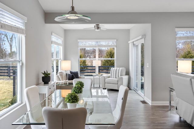 dining room with ceiling fan, dark wood-style flooring, and baseboards