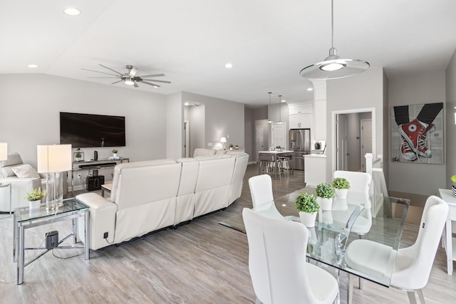 dining room featuring light wood-type flooring, lofted ceiling, a ceiling fan, and recessed lighting