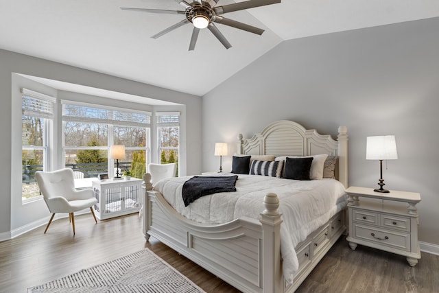 bedroom featuring lofted ceiling, dark wood-style floors, baseboards, and a ceiling fan