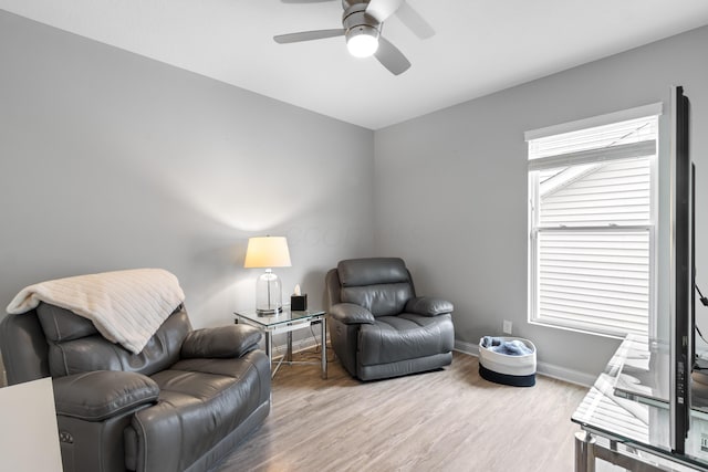 sitting room with light wood-type flooring, ceiling fan, and baseboards