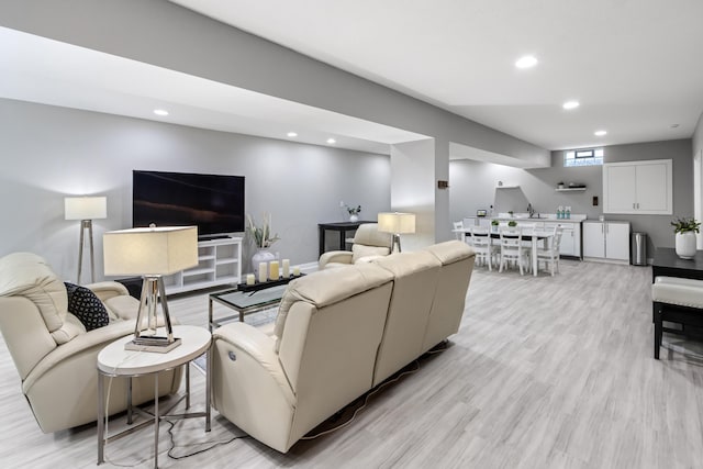 living area featuring recessed lighting and light wood-style flooring