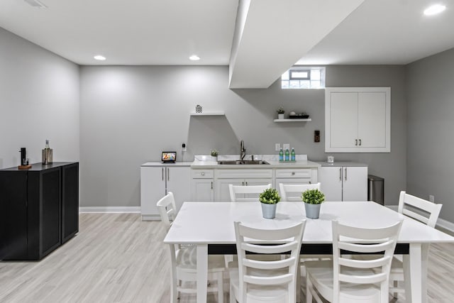 dining area with light wood-style flooring, baseboards, and recessed lighting