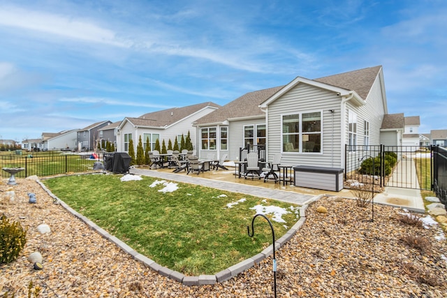 back of house with a residential view, a patio area, a yard, and fence private yard