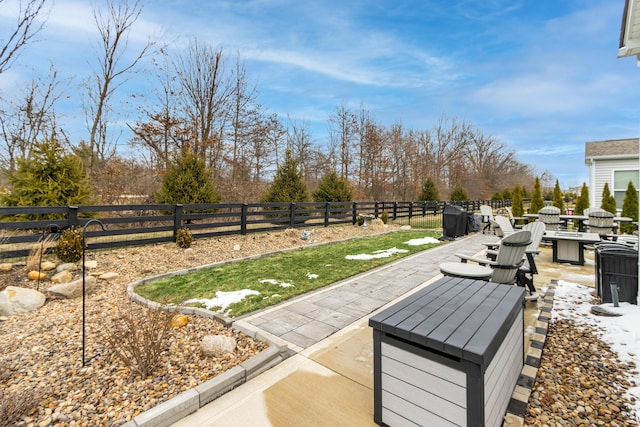 exterior space featuring an outdoor fire pit and a fenced backyard