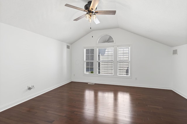 empty room featuring baseboards, a ceiling fan, lofted ceiling, and dark wood-type flooring