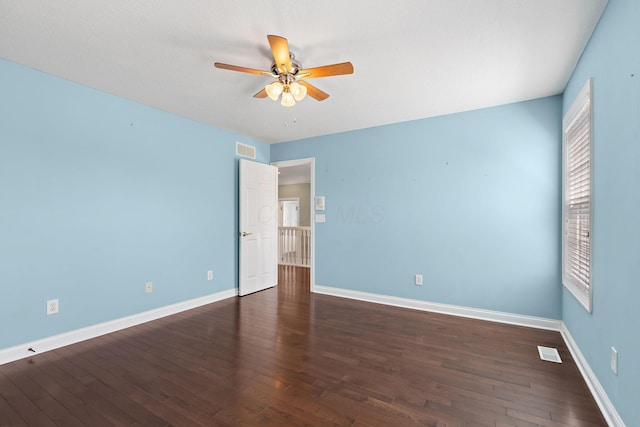 unfurnished room featuring a ceiling fan, visible vents, wood finished floors, and a healthy amount of sunlight