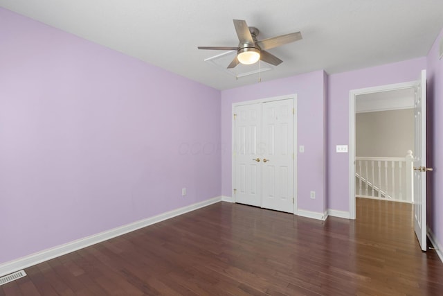 unfurnished bedroom featuring baseboards, visible vents, and wood finished floors