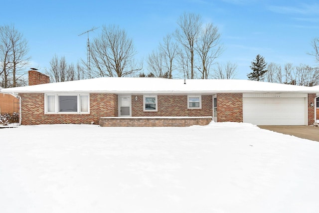 single story home featuring a garage, brick siding, and a chimney