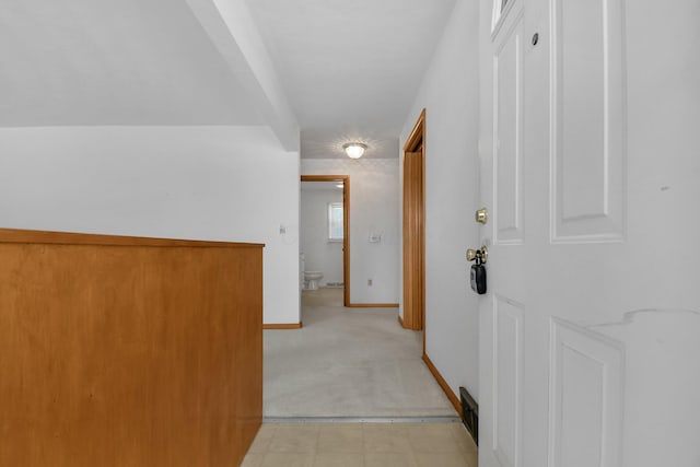 hall with light carpet and baseboards