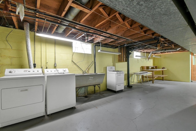 basement with independent washer and dryer and a sink