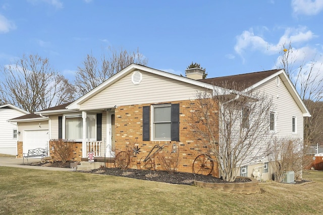 single story home with a garage, a chimney, a front lawn, and brick siding