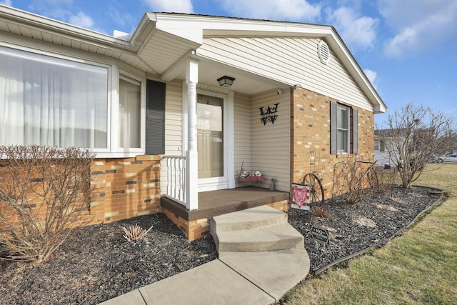 property entrance featuring brick siding