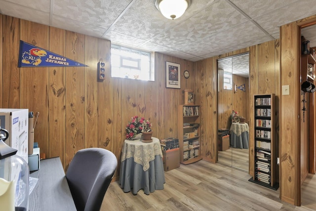 office area featuring wooden walls and wood finished floors