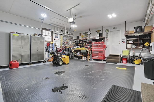 garage with a workshop area and a garage door opener