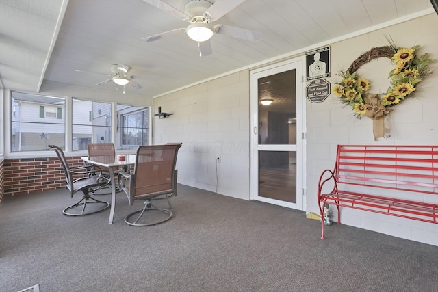 sunroom / solarium featuring ceiling fan