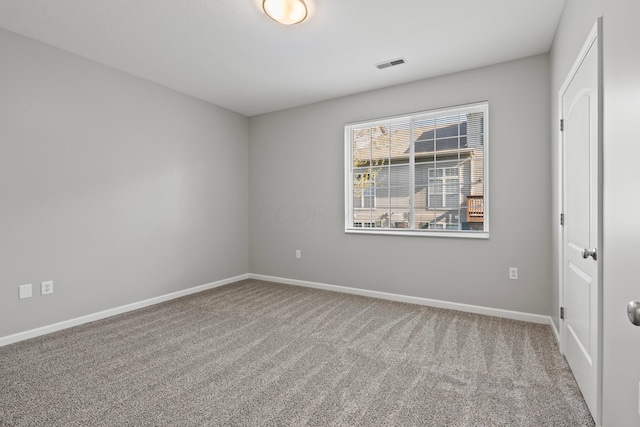 carpeted empty room with baseboards and visible vents