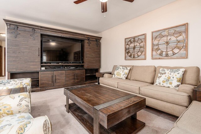 living area with light colored carpet and ceiling fan