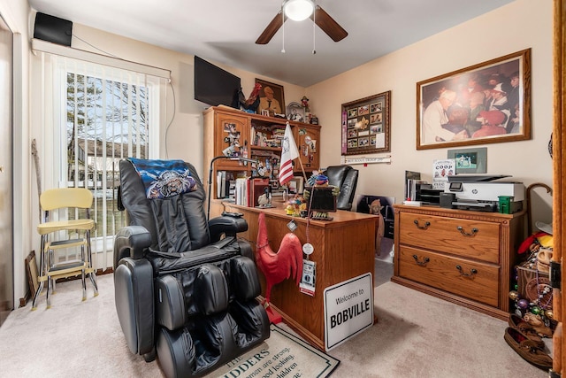 office area with a ceiling fan and light colored carpet