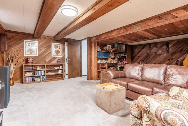 living area with carpet, beam ceiling, and wooden walls