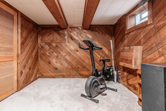 workout room featuring carpet floors and wooden walls