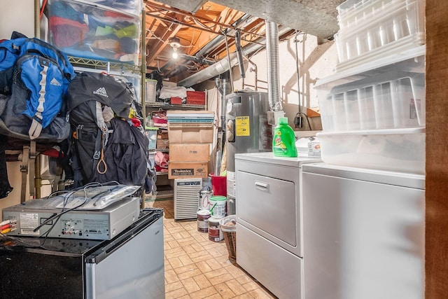 interior space featuring brick floor, electric water heater, and washing machine and clothes dryer