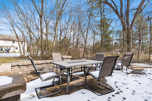 snow covered patio featuring outdoor dining space