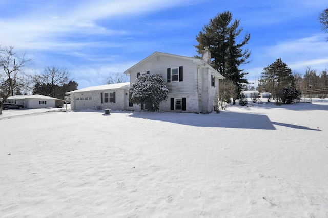 view of front of property featuring a garage and a chimney