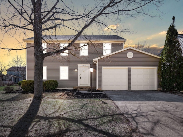 view of front facade with a garage and concrete driveway