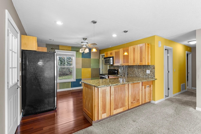 kitchen with light stone counters, visible vents, decorative backsplash, appliances with stainless steel finishes, and a peninsula