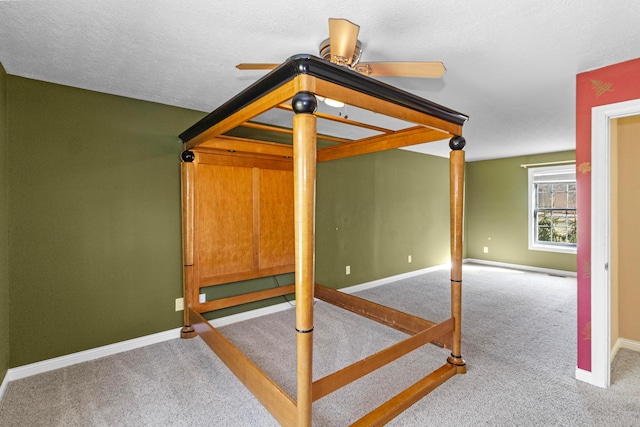 carpeted bedroom with a textured ceiling and baseboards