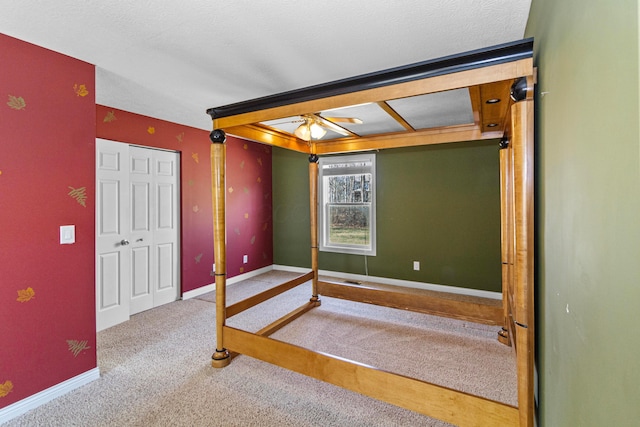 unfurnished bedroom with carpet and baseboards